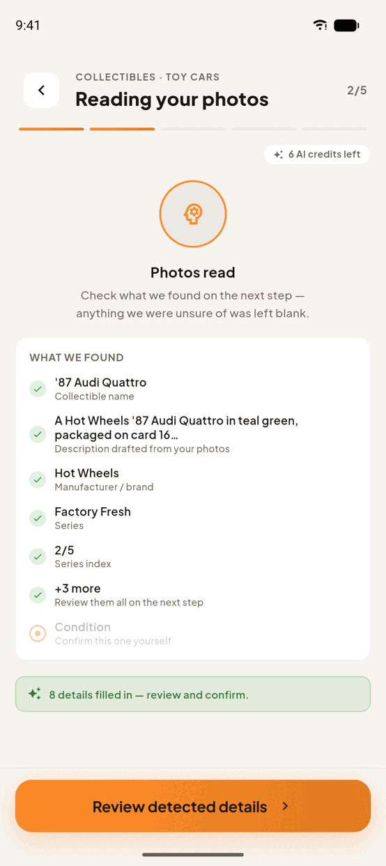 Step 2 of the add flow, Reading your photos: the AI has read a photograph and listed what it found — the name ’84 Audi Quattro, a written description, Hot Wheels as the manufacturer, Factory Fresh as the series and a 2 of 5 series index, six details in all